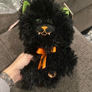 NWT singing spinning cat stuffed animal. Stands about 11 in tall.